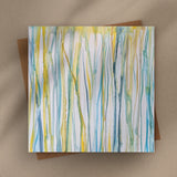 Flat lay of a 6×6 blank watercolor note card “Verdent Streams” with kraft envelope on tabletop—perfect blank thank you cards, baby shower thank you cards, graduation thank you cards, wedding note.
