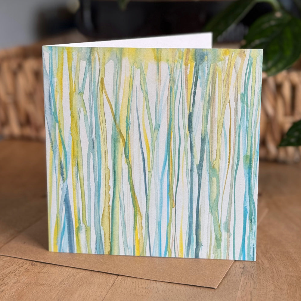 Portrait view of a 6×6 blank watercolor note card “Verdent Streams” with kraft envelope on tabletop—perfect blank thank you cards, baby shower thank you cards, graduation thank you cards, wedding note.