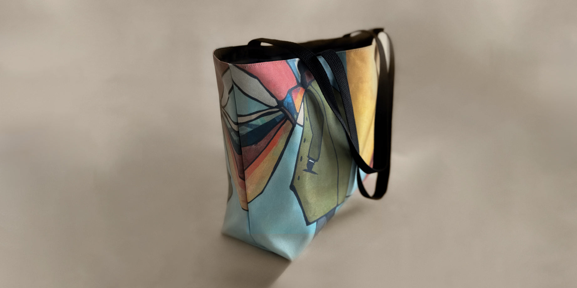 Side view of a tote and carry Weekender Tote with Ashlie + Archer design by GraylingHome.com, featuring a colorful abstract art print and black straps; canvas-feel tote bag for everyday use, cute tote bag, great gift idea for women or men
