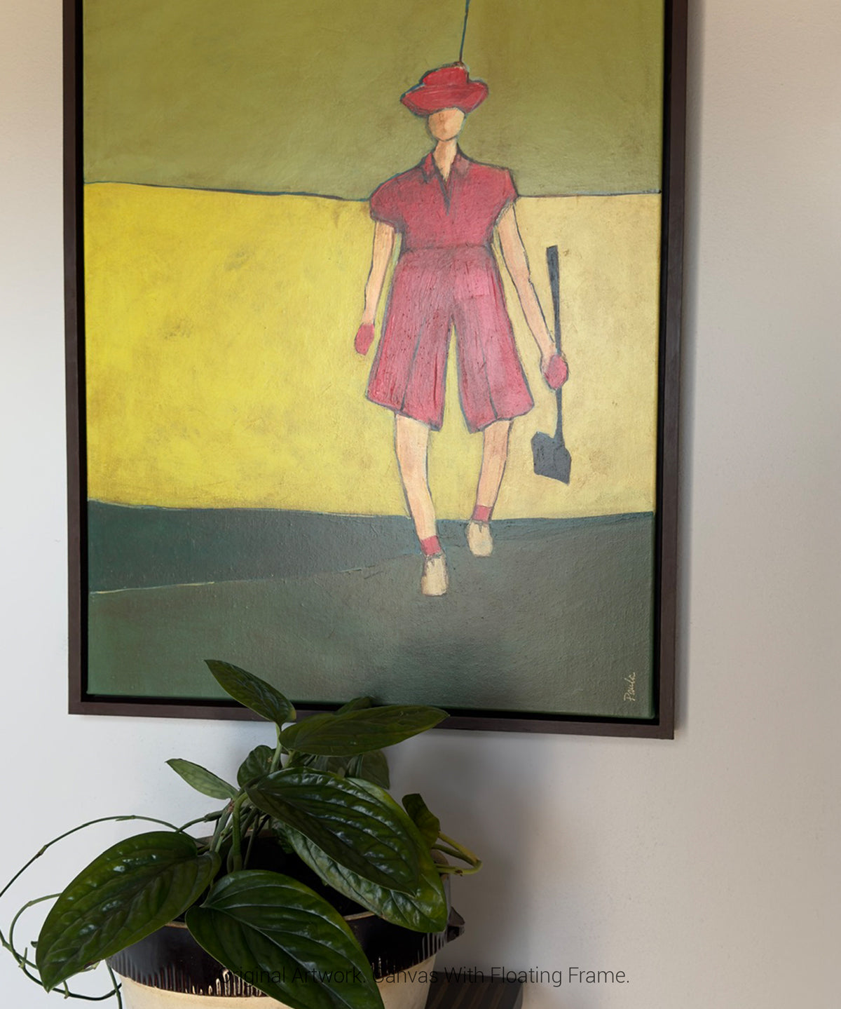 Framed wall art of a female golfer in pink displayed in a floating dark wood frame, modern artwork for home decor.