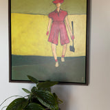 Framed wall art of a female golfer in pink displayed in a floating dark wood frame, modern artwork for home decor.