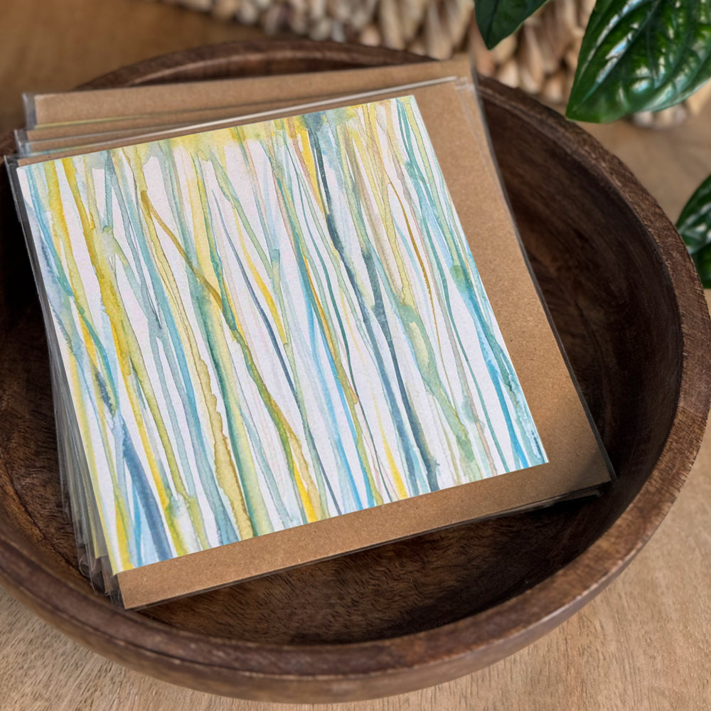 Set of cards in bowl of a 6×6 blank watercolor note card “Verdent Streams” with kraft envelope on tabletop—perfect blank thank you cards, baby shower thank you cards, graduation thank you cards, wedding note.
