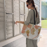 Woman opening mailbox with a large canvas tote bag, used as a reusable beach bag tote, everyday carryall, or cute tote bag for women. If you like Free People tote bags, then you’ll love this stylish weekender.