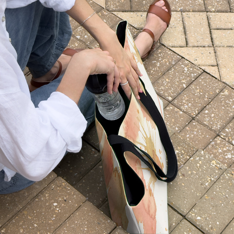 Overhead view of woman opening a large canvas tote bag, used as a reusable beach bag tote, everyday carryall, or cute tote bag for women. If you like Free People tote bags, then you’ll love this stylish weekender.
