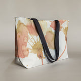 Studio front view of a large canvas tote bag, used as a reusable beach bag tote, everyday carryall, or cute tote bag for women. If you like Free People tote bags, then you’ll love this stylish weekender.