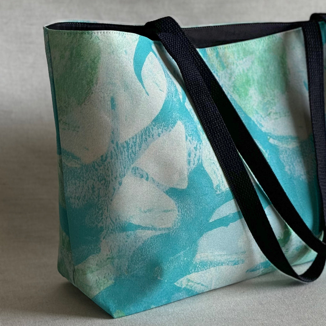 Studio close up view of a "Palm Beach" large canvas tote bag, used as a reusable beach bag tote, everyday carryall, or cute tote bag for women. If you like Free People tote bags, then you’ll love this stylish weekender.